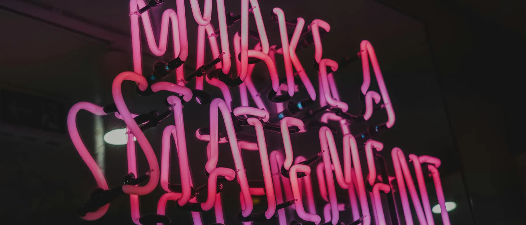 Neon sign reading “Make a Statement” symbolising transparent sustainability reporting for SMEs