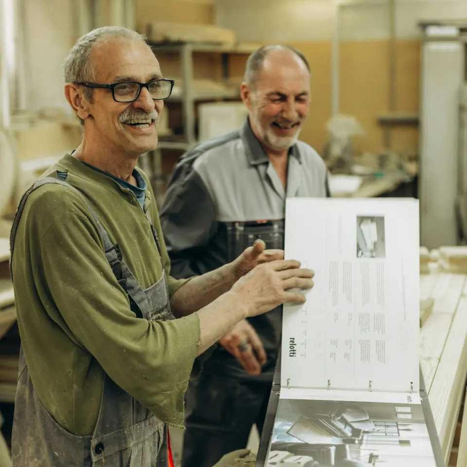 Two employees in a printing company reviewing a print product and checking the CO2 data of the production.